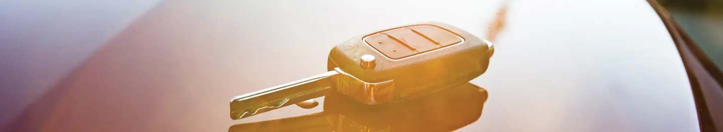 Car key on hood of car