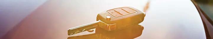 Car key on hood of car