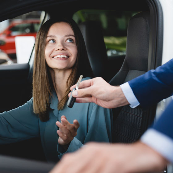 Woman taking keys after car maintenance