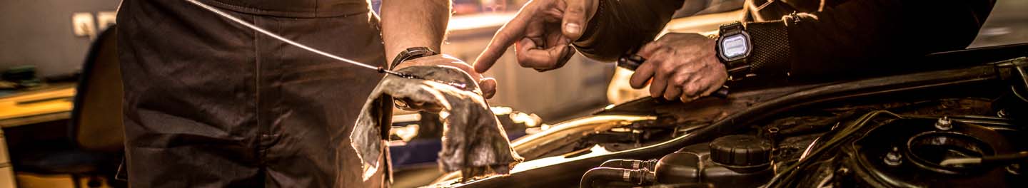 Pouring oil into car engine