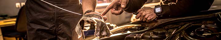 Pouring oil into car engine