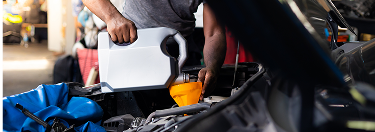 Changing the oil in a car.