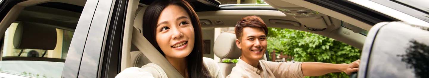 Two people smiling in car
