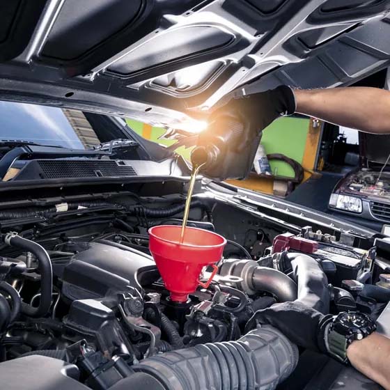 Pouring oil into a car's engine