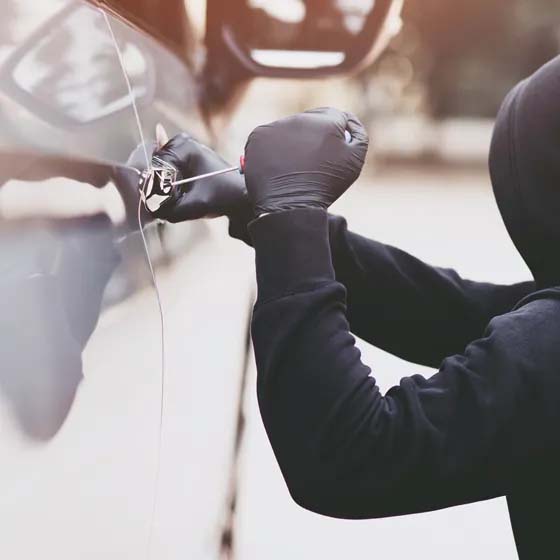 Thief breaking into car locks