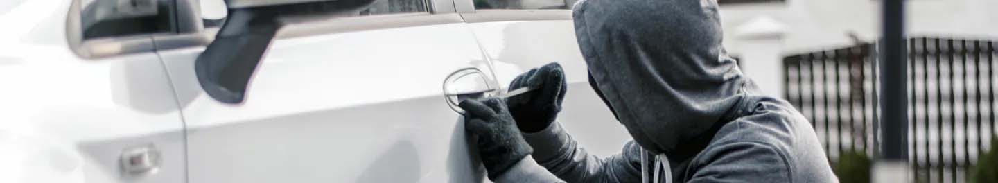 Thief trying to break into car