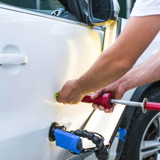 Dent repair on white car