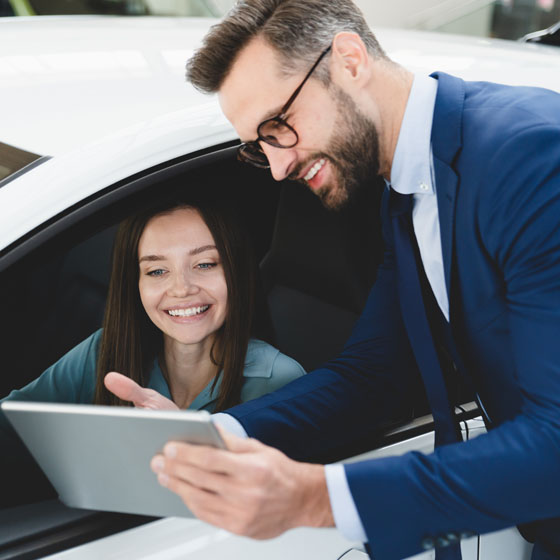Woman signing contract after car maintenance