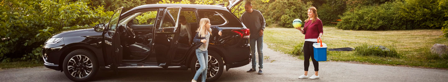 Family with SUV in driveway