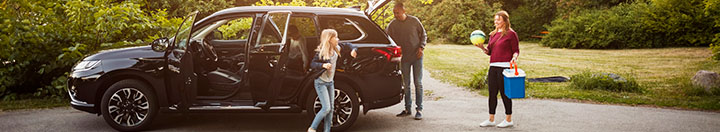 Family with SUV in driveway