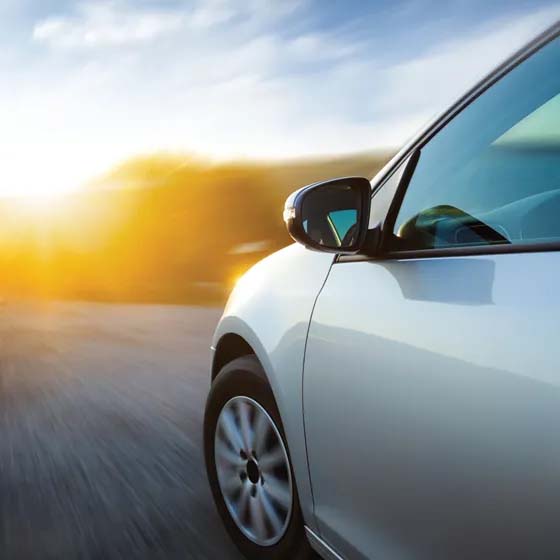 Silver car with sunset