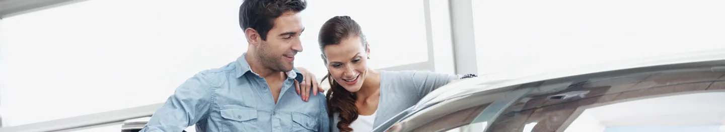 Man and woman looking at car
