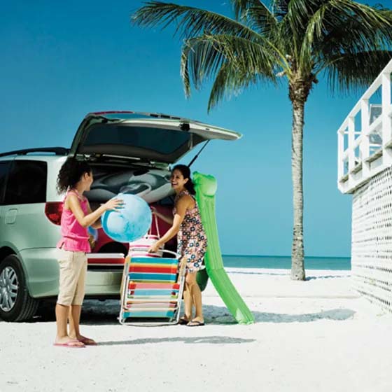 SUV with two people at the beach
