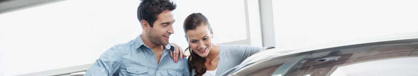 Man and woman looking at car