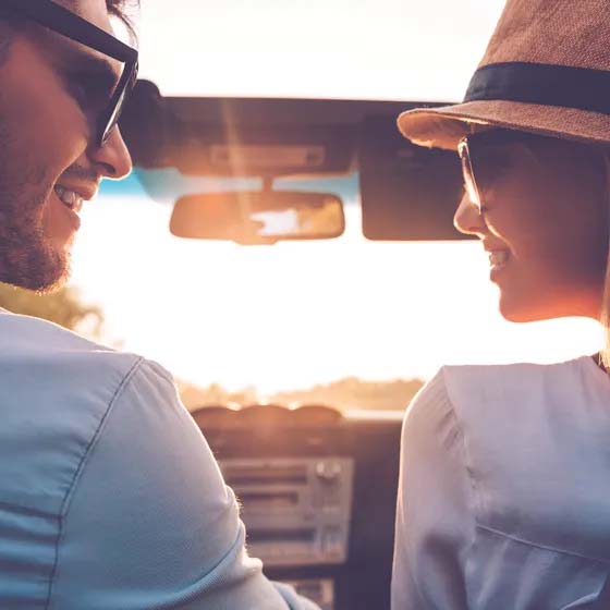 Two people in car looking at each other