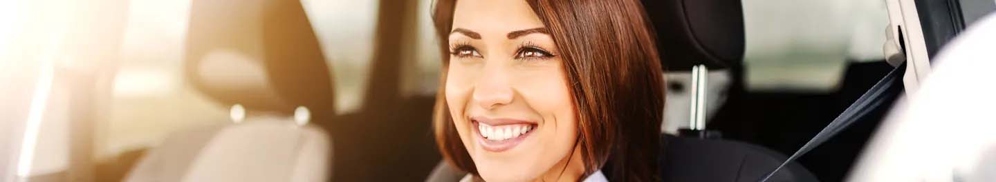 Woman smiling driving car