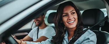 Woman and man in car smiling