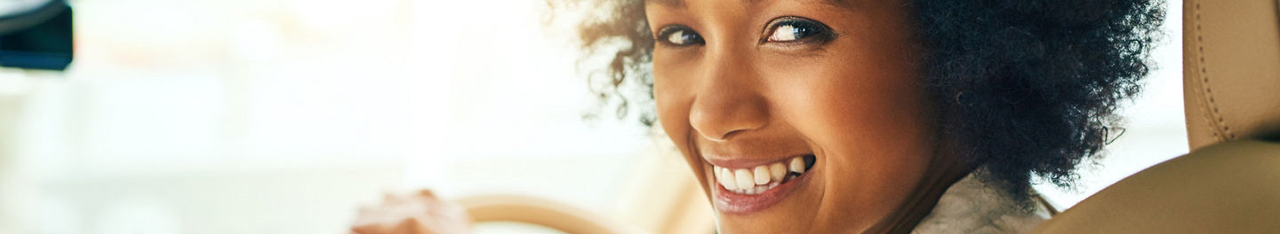 Woman in car smiling at camera