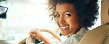 Woman in car smiling
