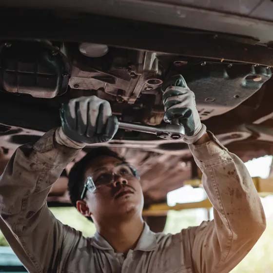 Man working on underneath of car