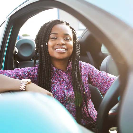 Woman in car with arm out window