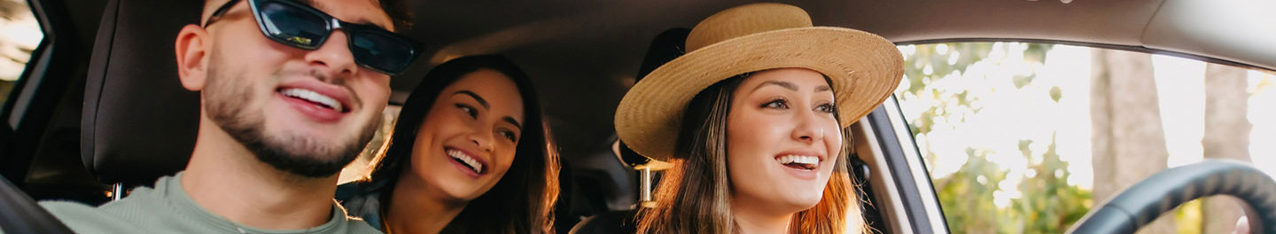 Friends in car smiling