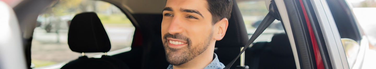 Man smiling in car