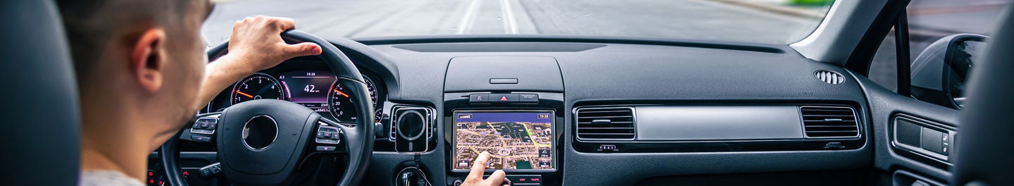 Man in car with electronics display