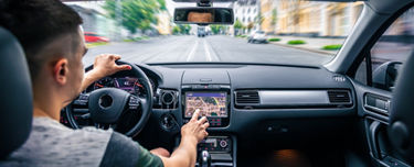 Man in car with electronics display