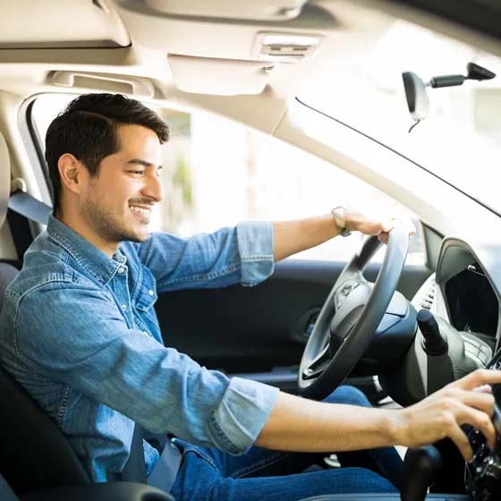 Man in car changing radio