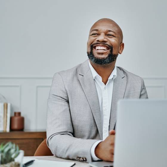 Man at computer smiling from Protective DOWC tax savings