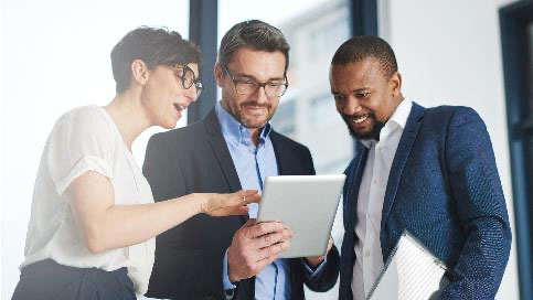 Three people looking at tablet