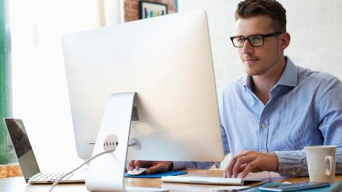 Man in glasses on computer