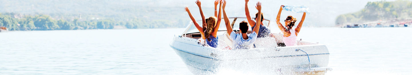 Friends on boat with hands up