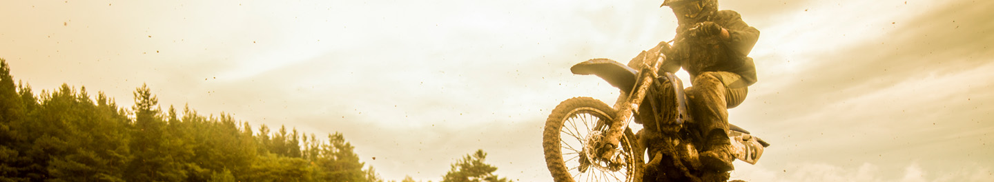 Dirt bike jumping at sunset