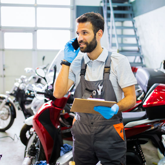 Motorcycle technician with clipboard 