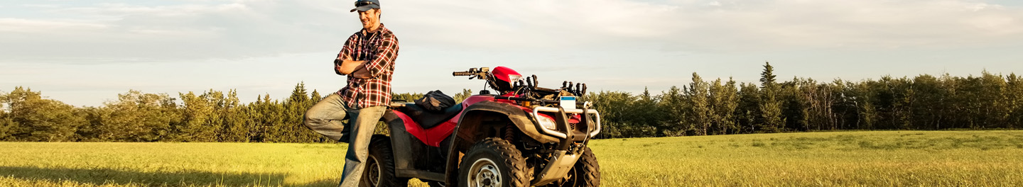 Man and ATV in a field 