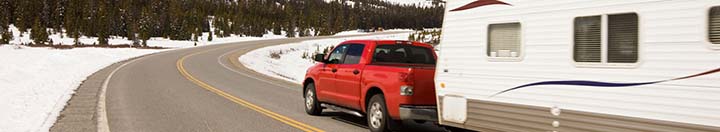 Truck pulling camper in winter