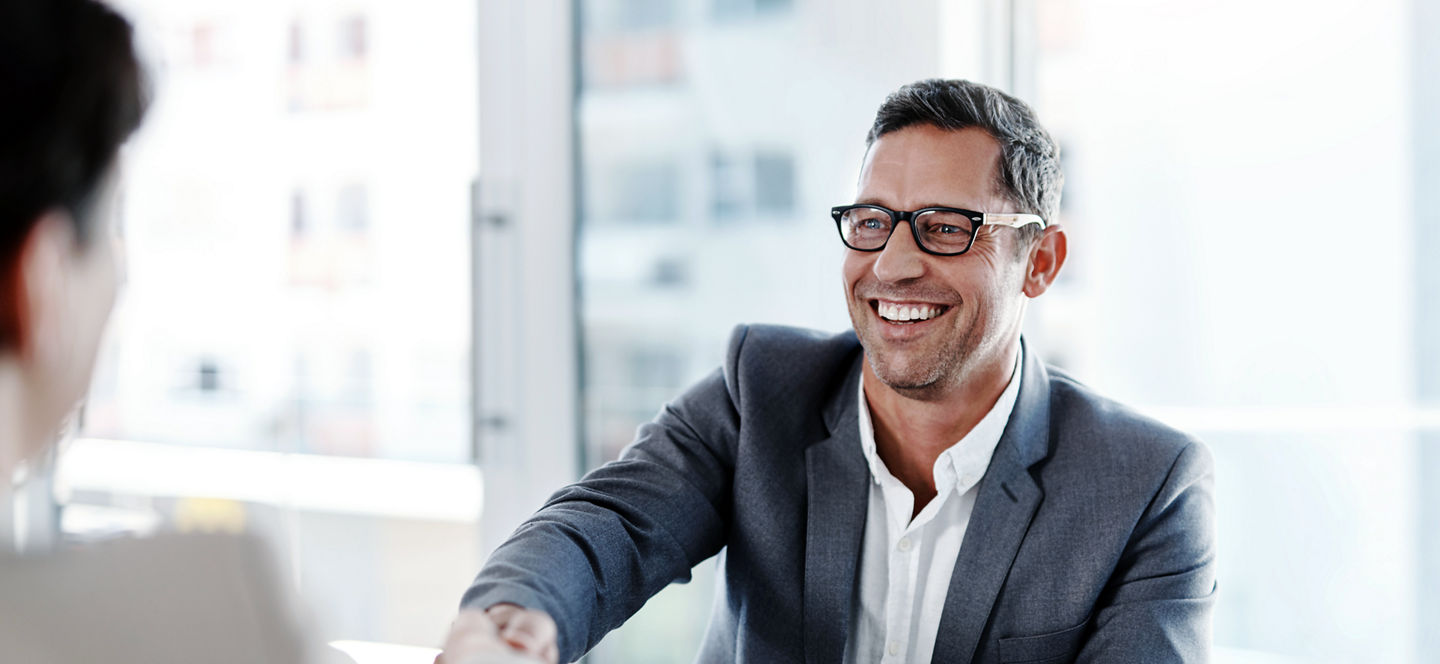 Man shaking hands in office